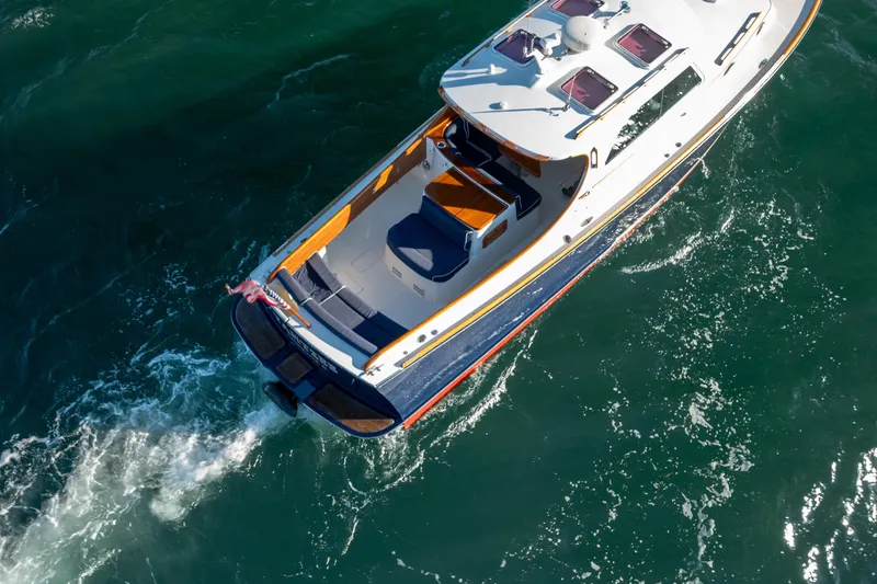 Slide: The Image of 2007 Hinckley Picnic Boat 36 EP cruising on open water, aerial view. - 5