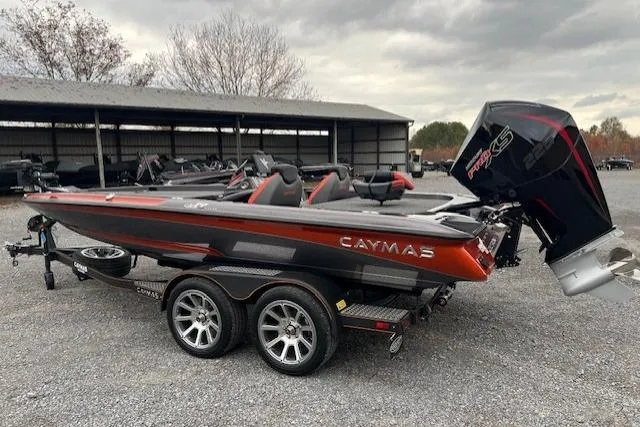Slide: The Image of 2026 Caymas CX 19 PRO boat on trailer, parked outdoors under cloudy sky. - 6