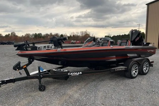 Slide: The Image of 2026 Caymas CX 19 PRO boat on trailer, parked outdoors under cloudy sky. - 7