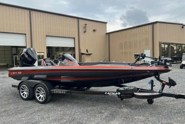 Slide: The Image of 2026 Caymas CX 19 PRO boat on trailer, parked outside industrial building. - 8