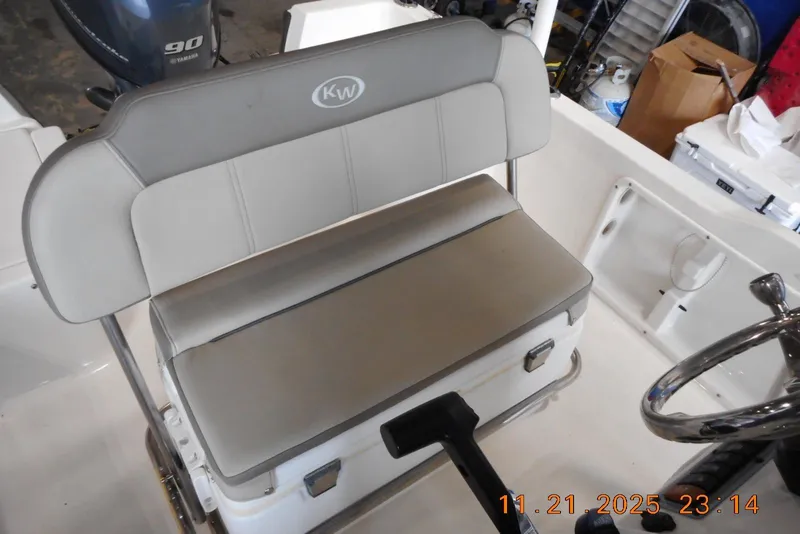 Slide: The Image of 2022 Key West 1720 Center Console boat interior with cushioned seating and steering wheel. - 14