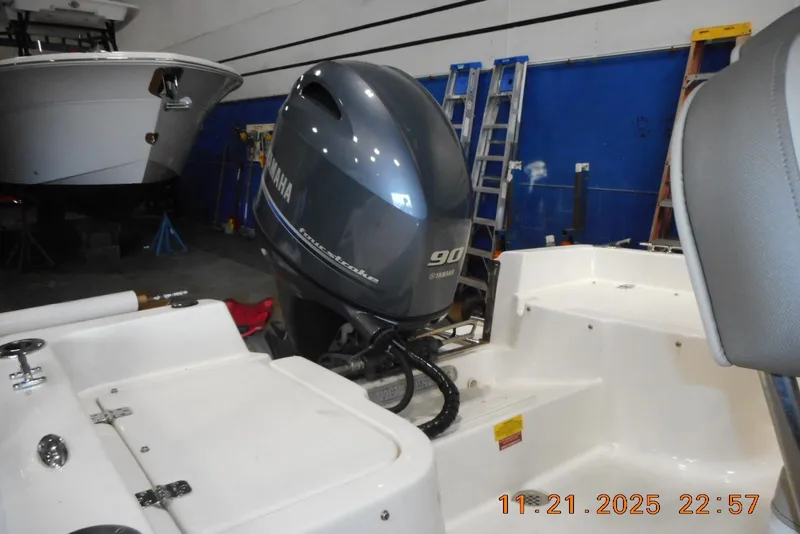 Slide: The Image of 2022 Key West 1720 Center Console with Yamaha 90 engine in a garage setting. - 17