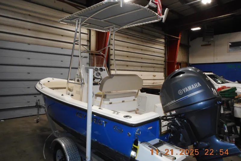 Slide: The Image of 2022 Key West 1720 Center Console boat with Yamaha outboard in a garage setting. - 2