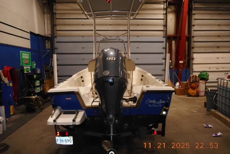 Slide: The Image of 2022 Key West 1720 Center Console boat in a garage, rear view with motor. - 3