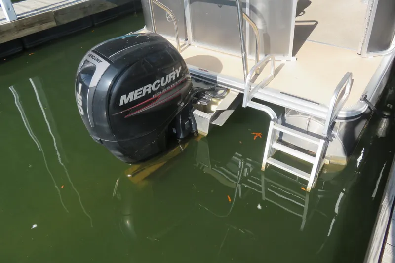 Slide: The Image of 2013 Cypress Cay Seabreeze 230 with Mercury outboard motor and swim ladder. - 4