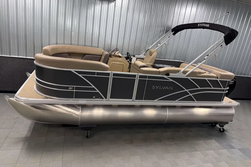 The Image of 2026 Sylvan Mirage 8520 Cruise pontoon boat in showroom, featuring sleek design and comfortable seating. - 0