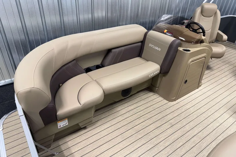 Slide: The Image of 2026 Sylvan Mirage 8520 Cruise boat interior with beige seating and steering console. - 2