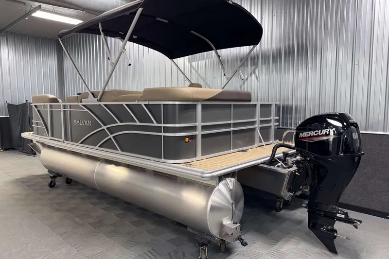 Slide: The Image of 2026 Sylvan Mirage 8520 Cruise pontoon boat with Mercury engine in a showroom. - 23