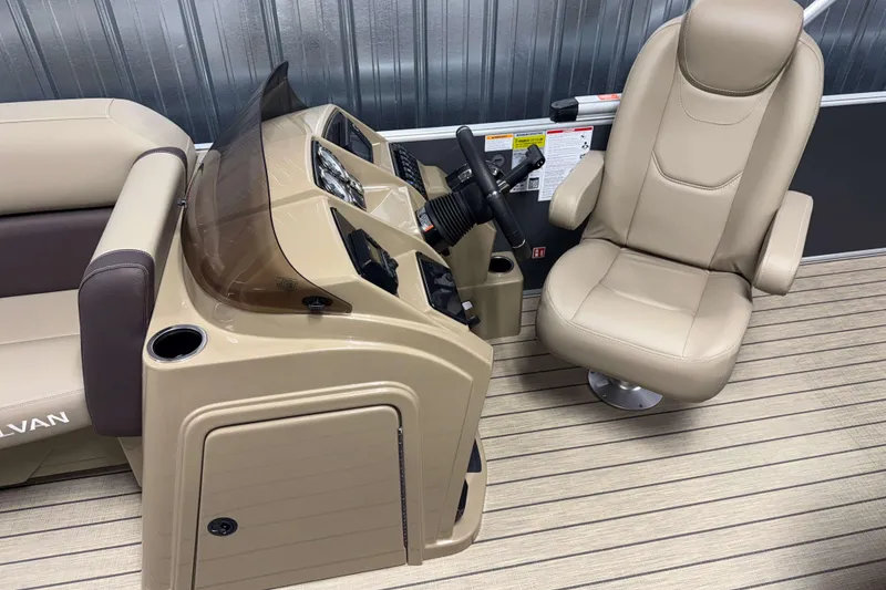 Slide: The Image of 2026 Sylvan Mirage 8520 Cruise boat interior with beige captain's chair and control panel. - 6