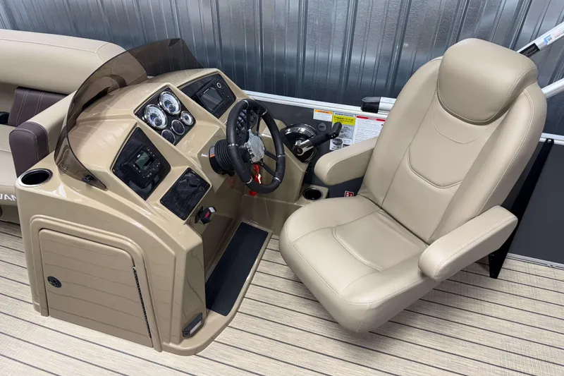 Slide: The Image of 2026 Sylvan Mirage 8520 Cruise boat helm with beige captain's chair and control panel. - 7