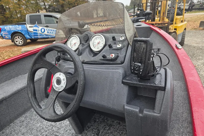 Slide: The Image of 2025 Tracker Super Guide V-16 SC boat dashboard with steering wheel and gauges. - 6