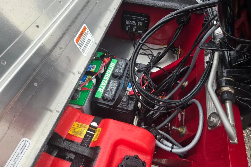 Slide: The Image of 2025 Tracker Super Guide V-16 SC boat battery compartment with wiring and Interstate battery. - 7