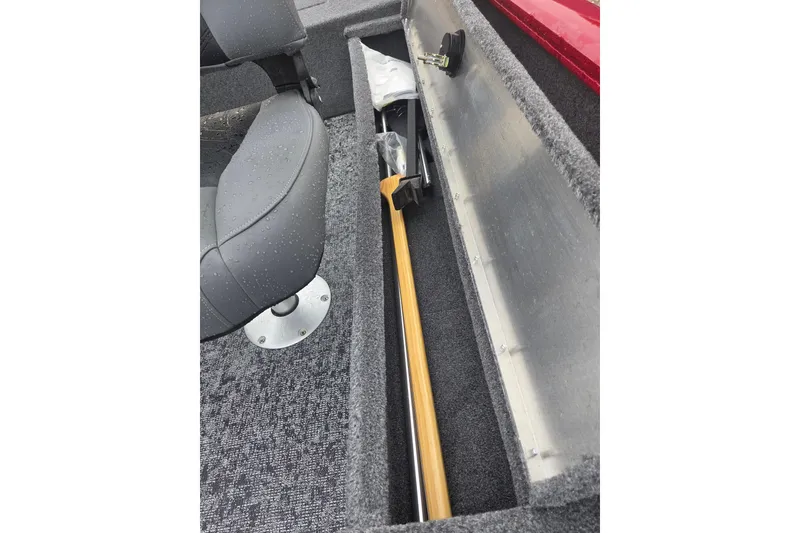 Slide: The Image of 2025 Tracker Super Guide V-16 SC boat interior with storage compartment and seat. - 8