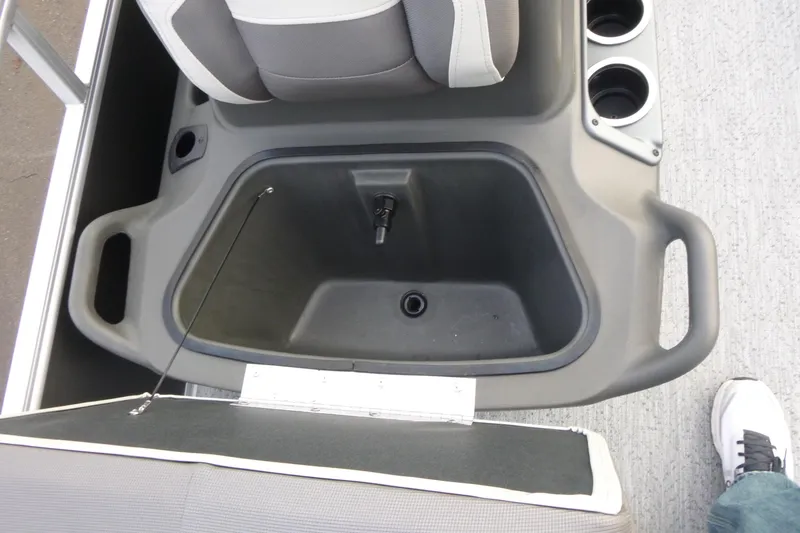 Slide: The Image of 2026 Sun Tracker Bass Buggy 16 XL Select boat seat storage compartment with cup holders. - 12