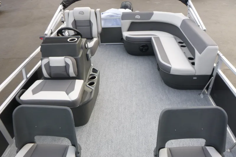 Slide: The Image of 2026 Sun Tracker Bass Buggy 16 XL Select pontoon boat interior with gray seating and steering console. - 13