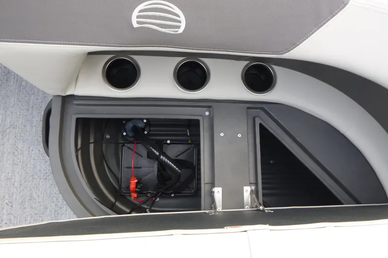 Slide: The Image of 2026 Sun Tracker Bass Buggy 16 XL Select interior storage compartment with cup holders. - 15