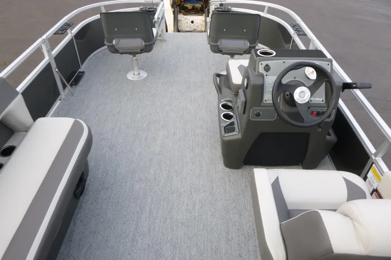 Slide: The Image of 2026 Sun Tracker Bass Buggy 16 XL Select pontoon boat interior with seating and steering console. - 6