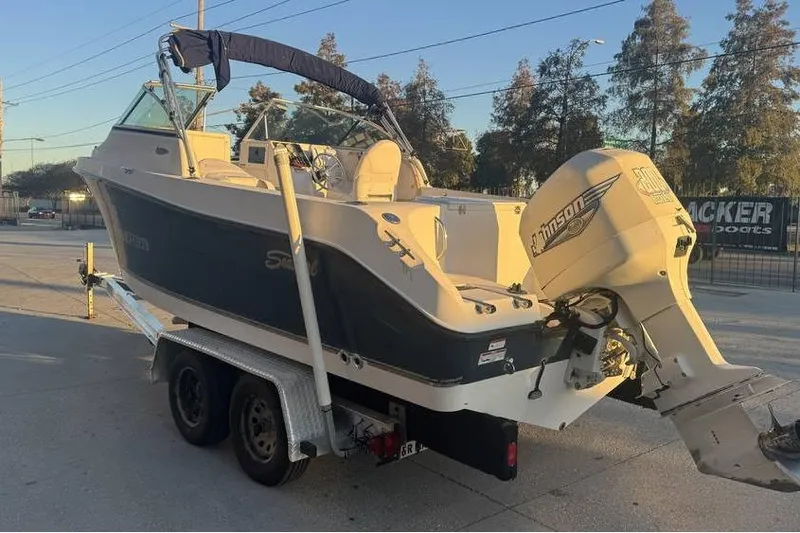 Slide: The Image of 2006 Seaswirl Striper 2101 Dual Console OB boat on trailer, featuring Johnson outboard motor. - 3
