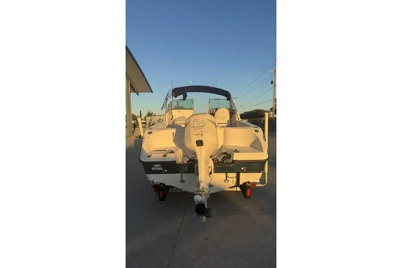 Slide: The Image of 2006 Seaswirl Striper 2101 Dual Console OB boat, rear view at sunset. - 4