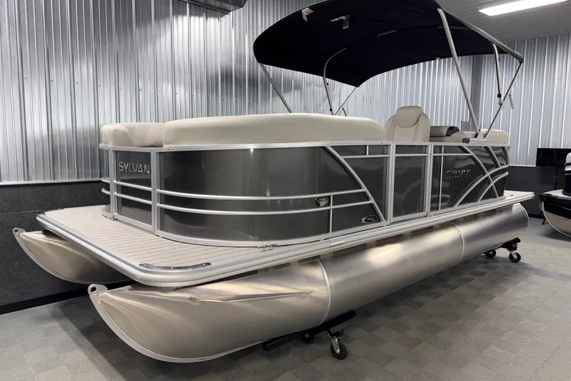 Slide: The Image of 2026 Sylvan Mirage 8520 LZ pontoon boat in showroom, featuring sleek design and modern amenities. - 17