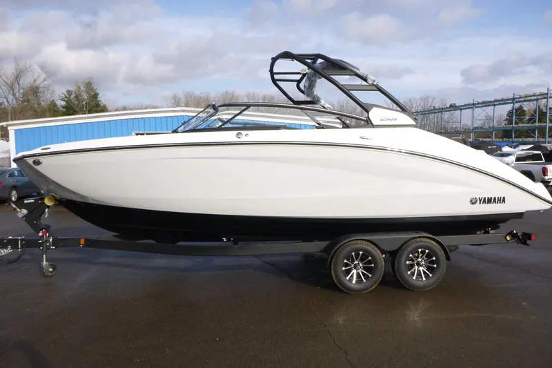 The Image of 2026 Yamaha Boats 252S on trailer, sleek design, parked outdoors. - 1