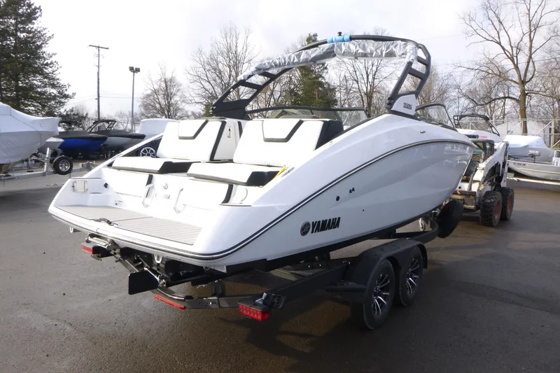 Slide: The Image of 2026 Yamaha Boats 252S on trailer, sleek design, parked outdoors. - 3
