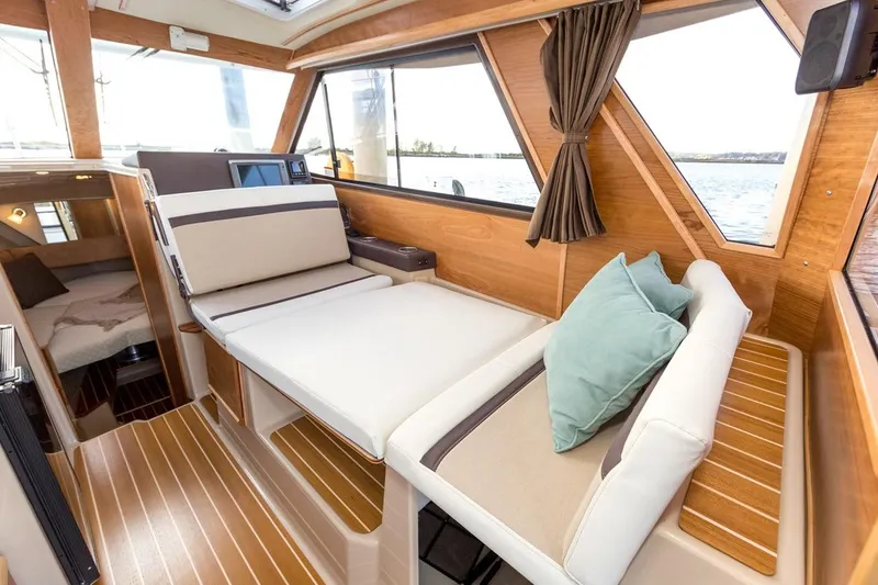 Slide: The Image of Manufacturer Provided Image: Interior of 2016 Cutwater 28 boat with wooden finishes and comfortable seating. - 11