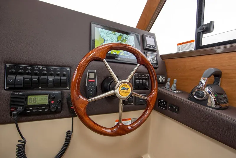 Slide: The Image of Manufacturer Provided Image: Cutwater 28 helm station with wooden steering wheel, navigation screens, and control panels, 2016 model. - 15