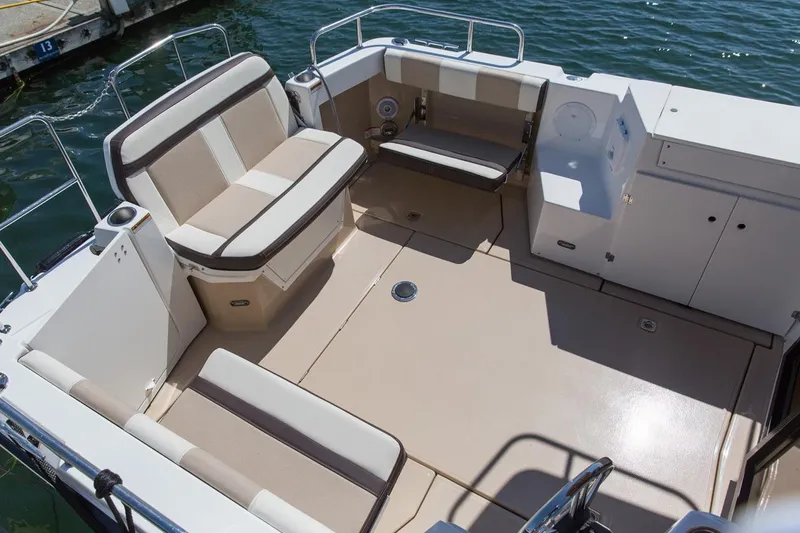 Slide: The Image of Manufacturer Provided Image: 2016 Cutwater 28 boat interior with beige seating and spacious deck. - 16