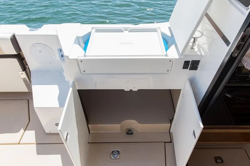 Slide: The Image of Manufacturer Provided Image: 2016 Cutwater 28 boat interior storage compartments and sink area. - 17