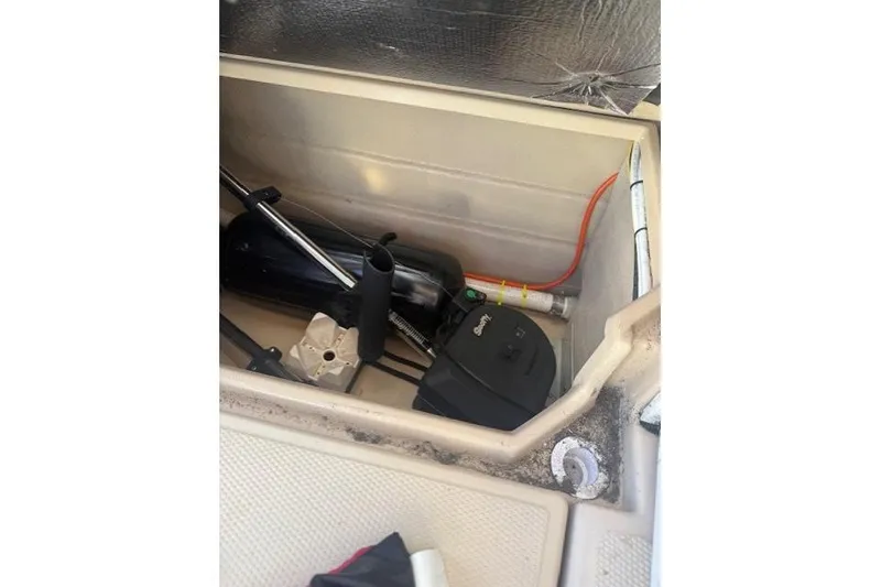 Slide: The Image of Storage compartment of a 2016 Cutwater 28 boat with equipment and wiring. - 7