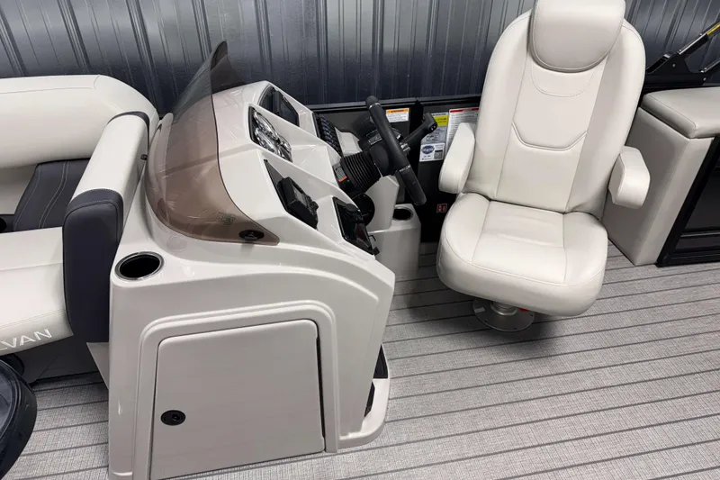 Slide: The Image of 2026 Sylvan Mirage 8520 CLZ DH boat interior with captain's chair and helm. - 6