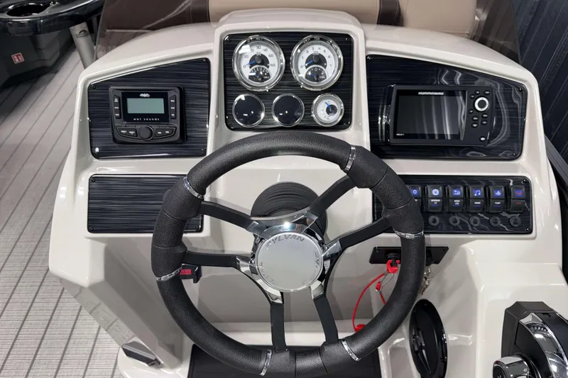 Slide: The Image of 2026 Sylvan Mirage 8520 CLZ DH boat dashboard with steering wheel and control panel. - 9