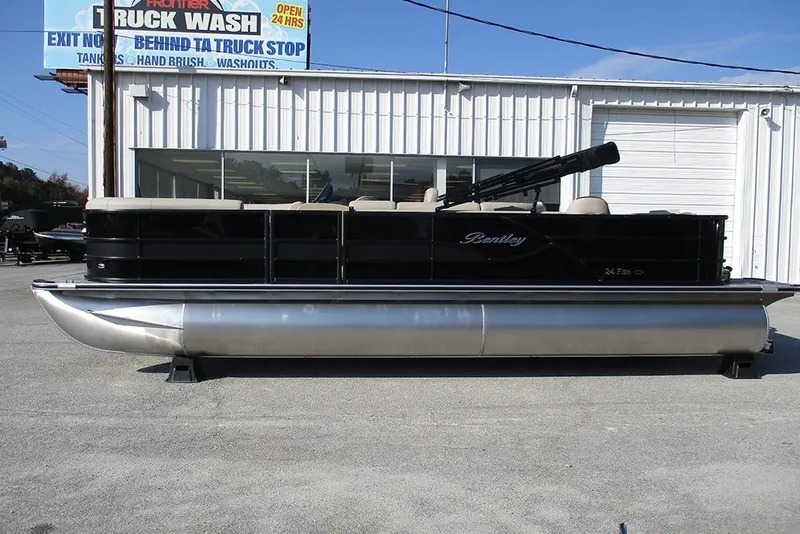 The Image of 2026 Bentley Pontoons Fish 243 N-Cruise pontoon boat parked outside a truck wash. - 1