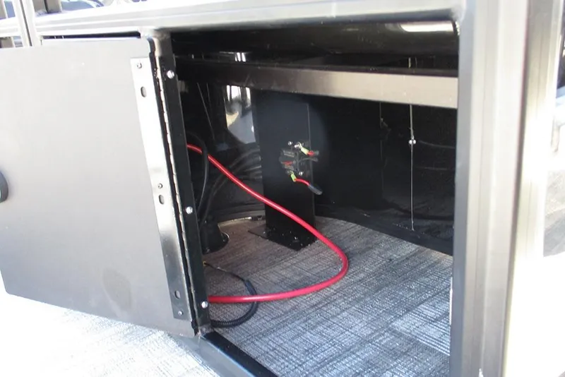 Slide: The Image of Open storage compartment in 2026 Bentley Pontoons Fish 243 N-Cruise with visible wiring. - 33