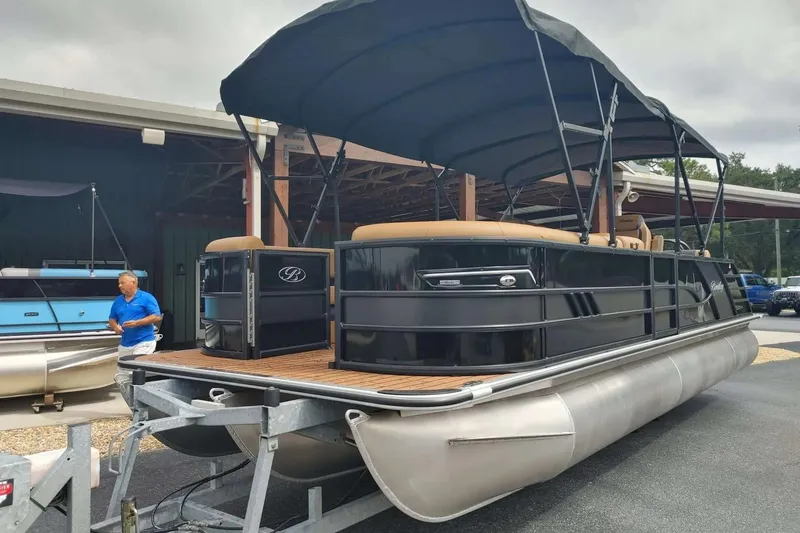 The Image of 2026 Bentley Pontoons Elite 253 Swingback in a showroom, showcasing sleek design and luxury features. - 0