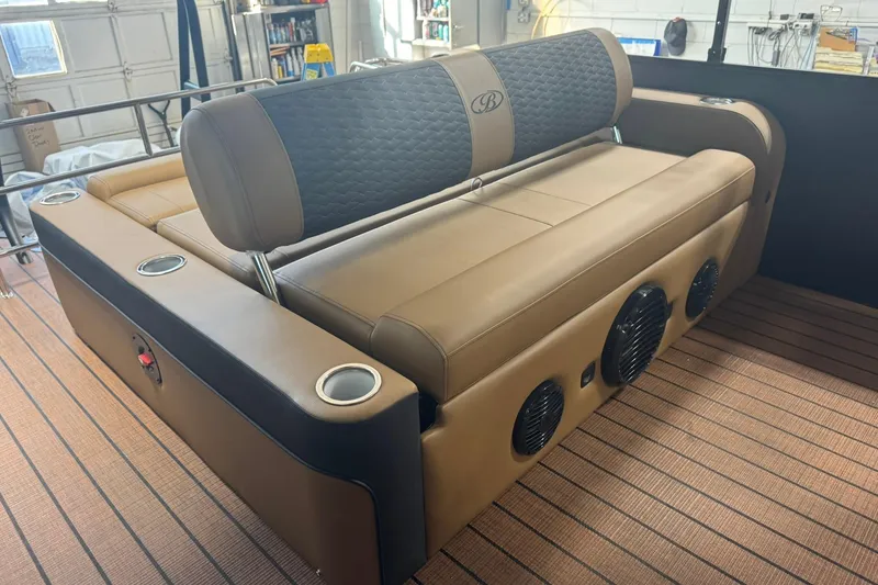 Slide: The Image of 2026 Bentley Pontoons Elite 253 Swingback interior with luxurious seating and integrated speakers. - 14