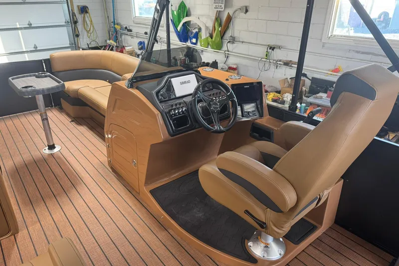 Slide: The Image of 2026 Bentley Pontoons Elite 253 Swingback interior with luxurious seating and modern dashboard. - 22