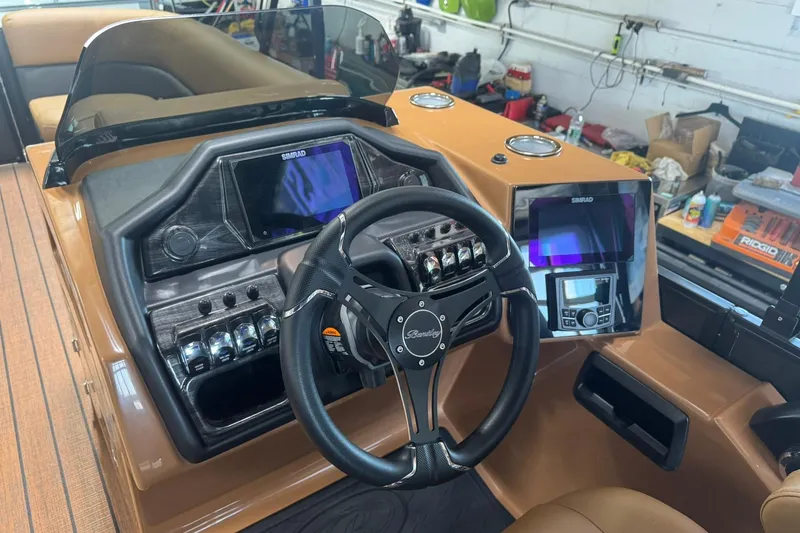 Slide: The Image of 2026 Bentley Pontoons Elite 253 Swingback dashboard with steering wheel and control panels. - 23