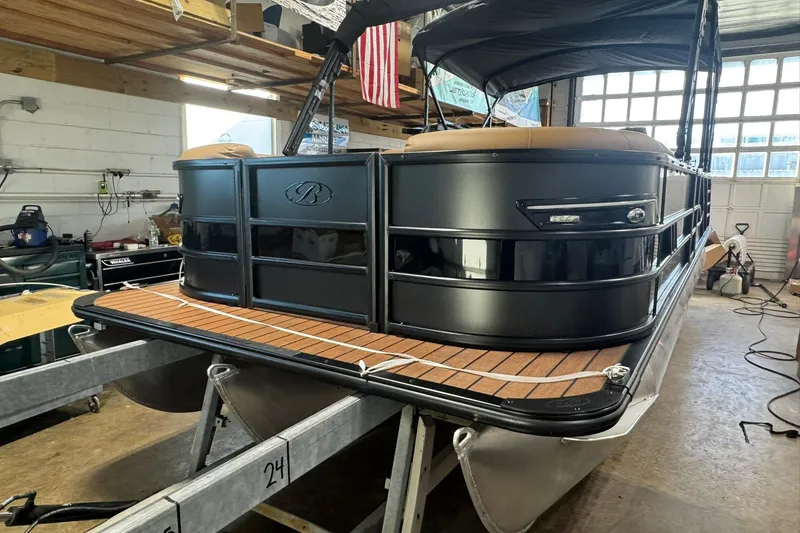 Slide: The Image of 2026 Bentley Pontoons Elite 253 Swingback in a garage, showcasing sleek design and luxury features. - 28