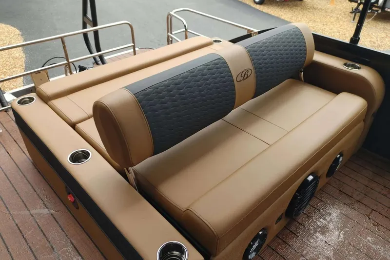 Slide: The Image of 2026 Bentley Pontoons Elite 253 Swingback with luxurious tan seating and cup holders. - 6