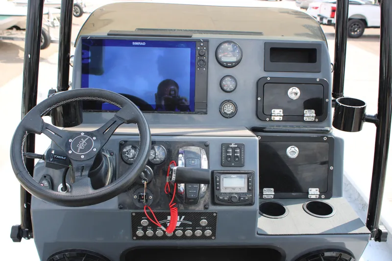 Slide: The Image of Two black seats with rod holders on a 2025 Mamba 24 Cat Classic boat. - 10