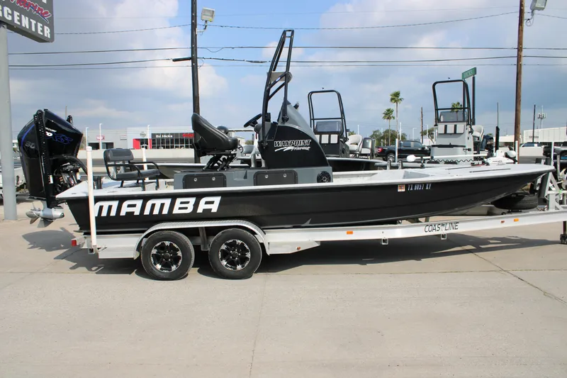 Slide: The Image of 2025 Mamba 24 Cat Classic boat on trailer at dealership, side view. - 18