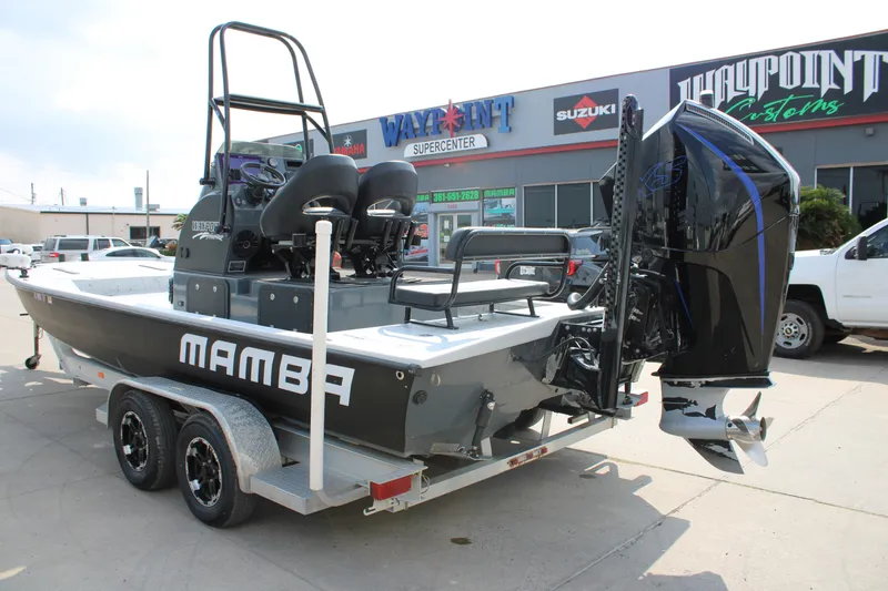 Slide: The Image of 2025 Mamba 24 Cat Classic boat on trailer, featuring powerful outboard engine. - 2