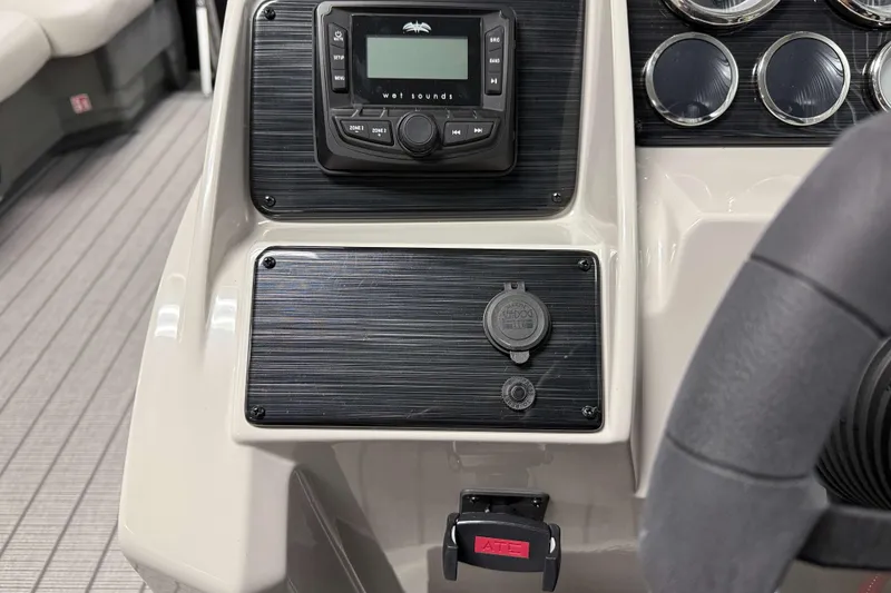 Slide: The Image of Control panel of 2026 Sylvan Mirage 8520 LZ boat with audio system and gauges. - 13