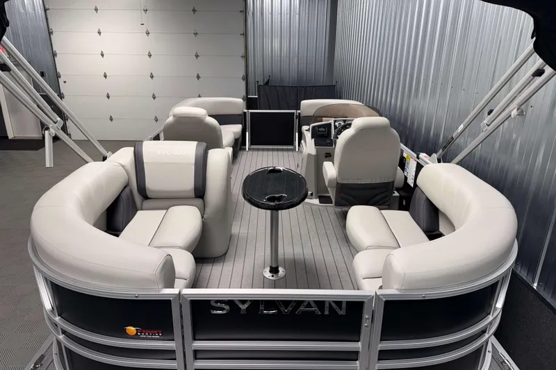 Slide: The Image of 2026 Sylvan Mirage 8520 LZ pontoon boat with luxurious seating in a garage setting. - 16