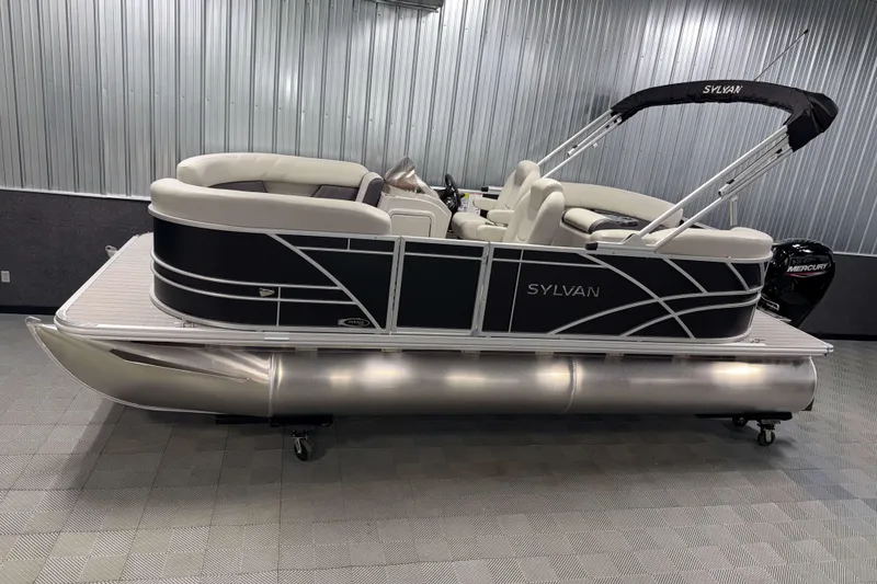 Slide: The Image of 2026 Sylvan Mirage 8520 LZ pontoon boat in showroom, featuring sleek design and comfortable seating. - 17