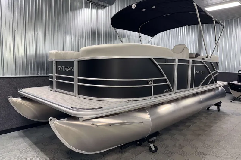 Slide: The Image of 2026 Sylvan Mirage 8520 LZ pontoon boat in a showroom with sleek design. - 18