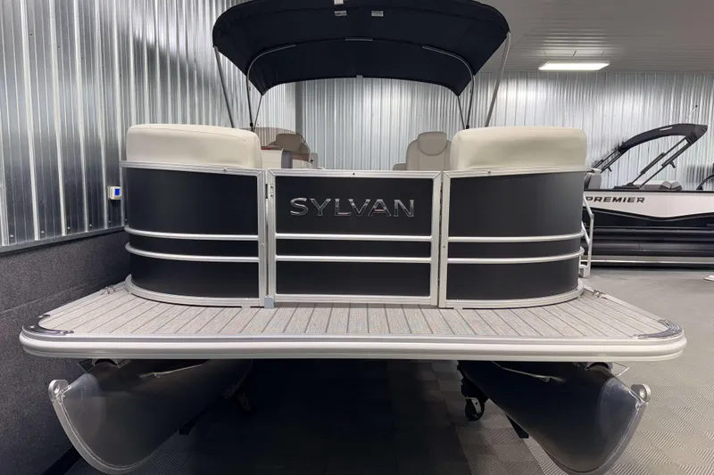 Slide: The Image of 2026 Sylvan Mirage 8520 LZ pontoon boat in showroom, featuring sleek design and modern amenities. - 19