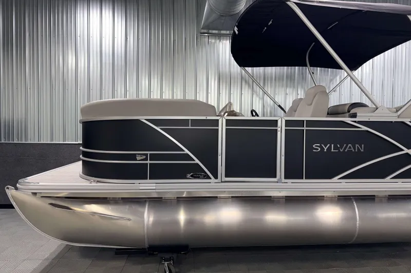 Slide: The Image of 2026 Sylvan Mirage 8520 LZ pontoon boat in a sleek indoor setting. - 20